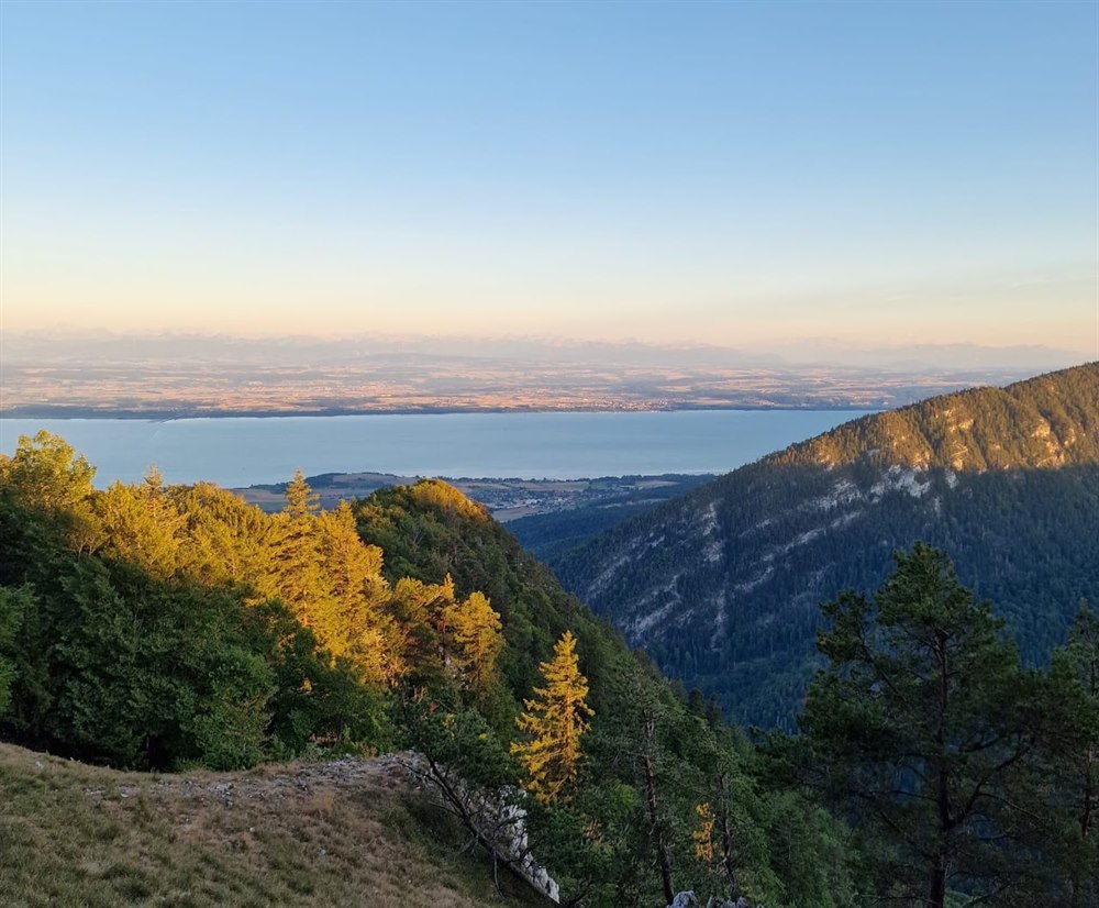 A Swiss lake seen from a mountain ridge at sunset
